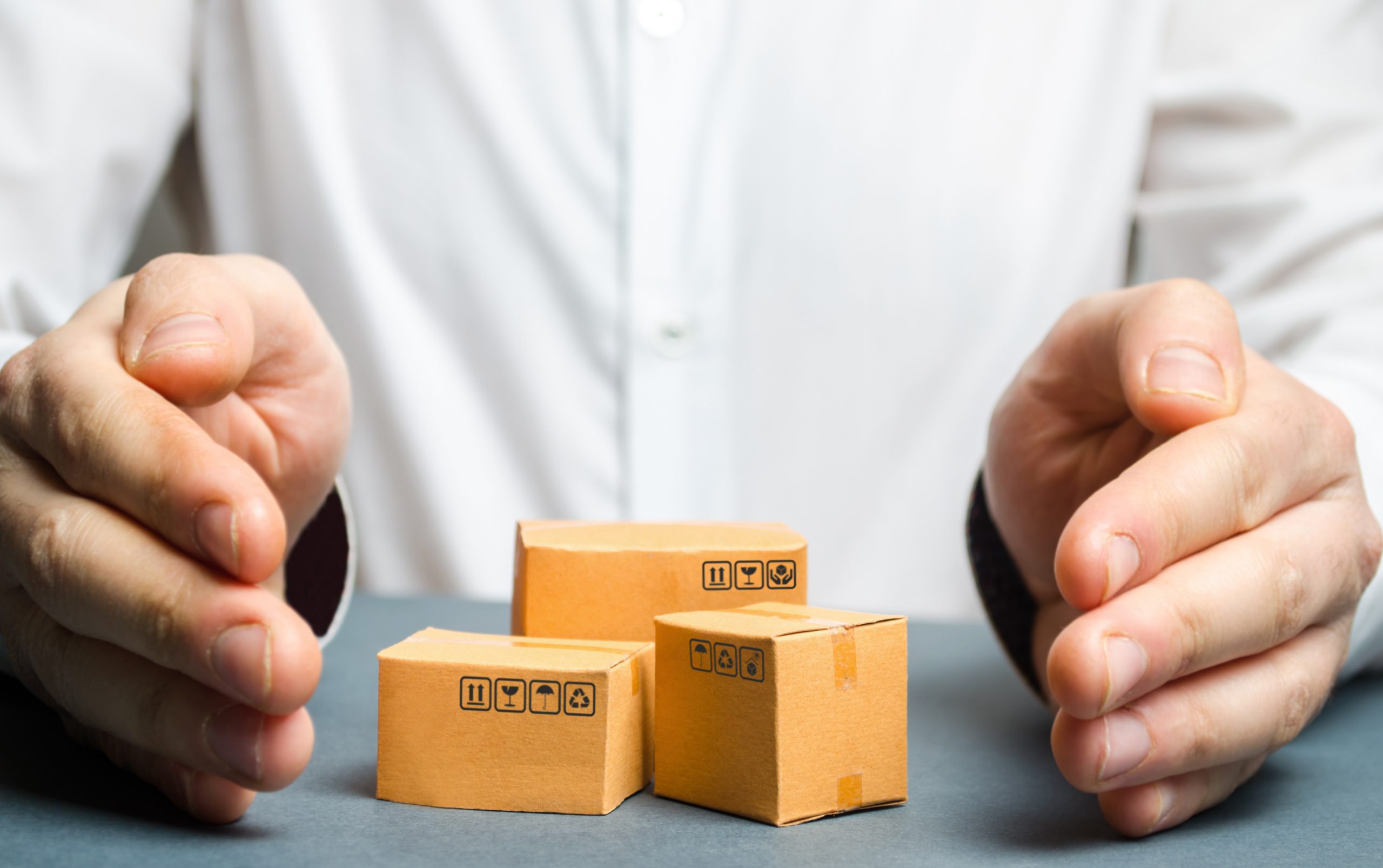 A,Man,Covers,His,Hands,With,Cardboard,Boxes,Or,Goods.