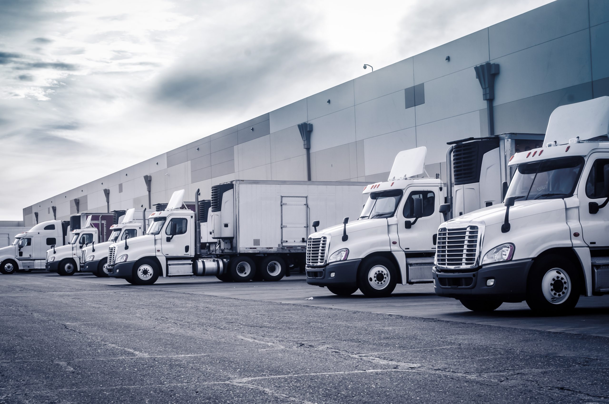 Delivering,Or,Supply,Concept,Image.,Trucks,Loading,At,Facility.